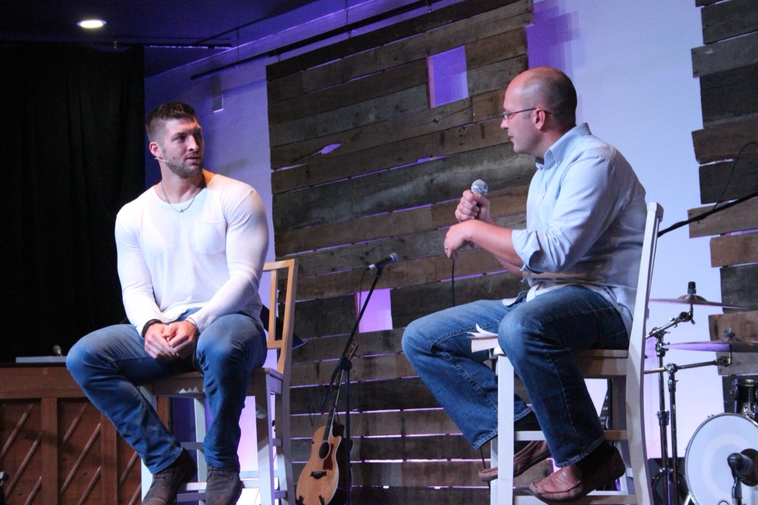 Pat Ward on stage at a church event